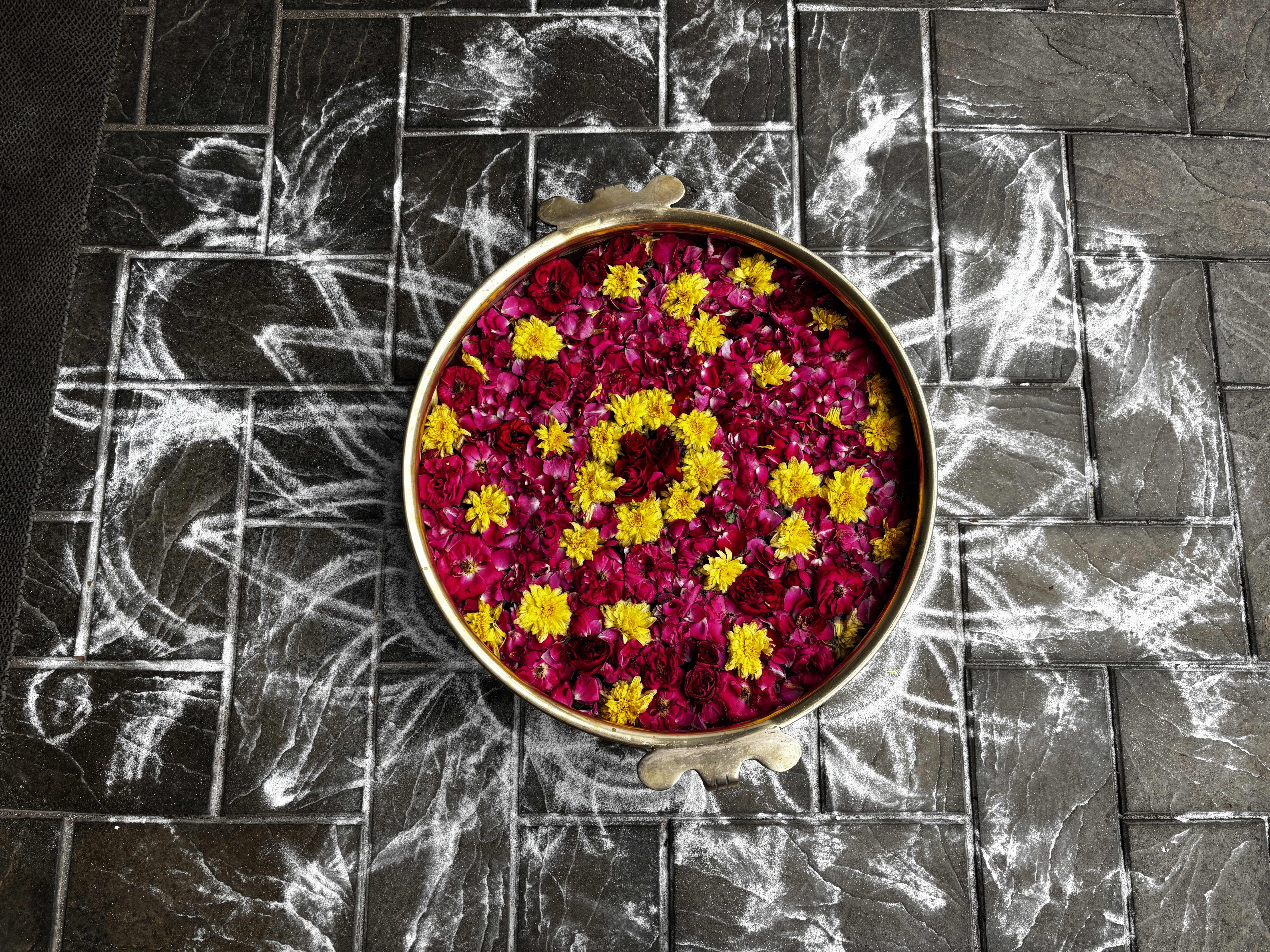 An Urli decorated with flower petals
